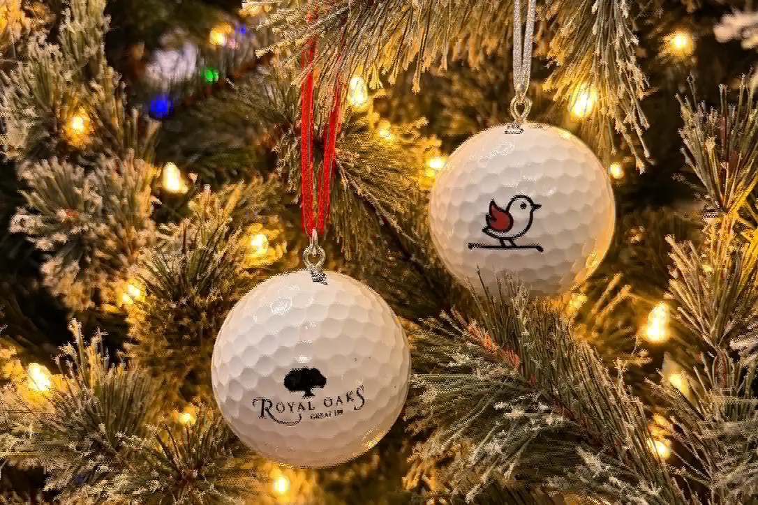 Custom golf ball ornaments hanging on a Christmas tree