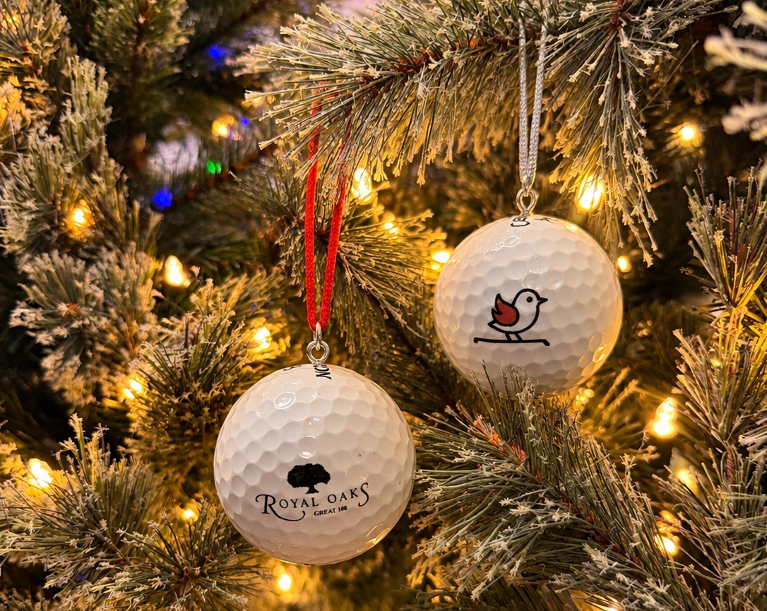 Custom golf ball ornaments hanging on a Christmas tree