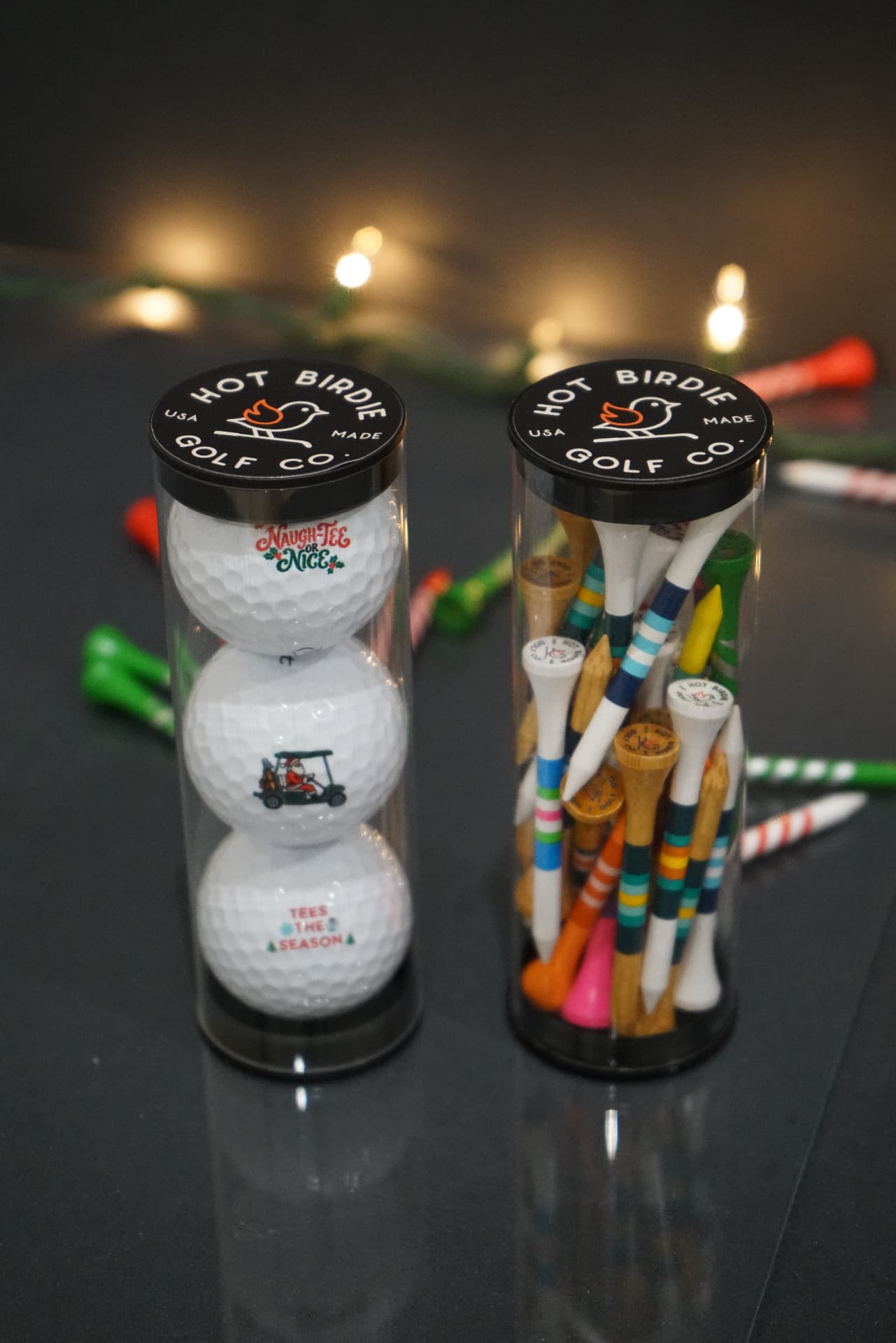 Three-ball holiday sleeve next to a tube of thirty tees