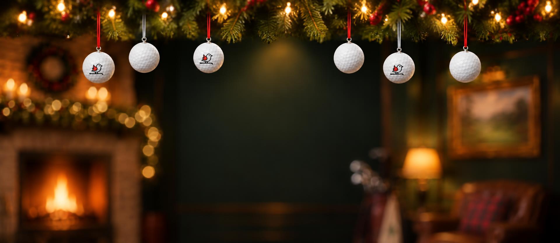 Cozy clubhouse scene with golf ball ornaments hanging from a garland, a leather armchair, golf bag and a warm fireplace